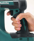 Close-up of hand gripping 18V LXT Cordless 2-Inch Brad Nailer With 110-Nail Magazine, lightweight design ideal for precision nailing.