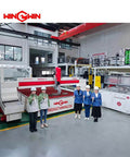 WinWin waterjet cutting system in factory; red and white machine with control units and workers in safety gear.