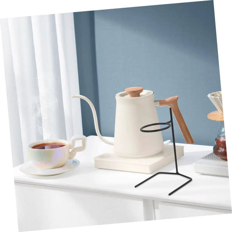 Pair Of Portable Coffee Dripper Holder And Filter Stand For Home Barista Rigs Or Weekend Warrior Campout Vibes Smooth Pour Station showing black metal stand beside a white kettle and cup.