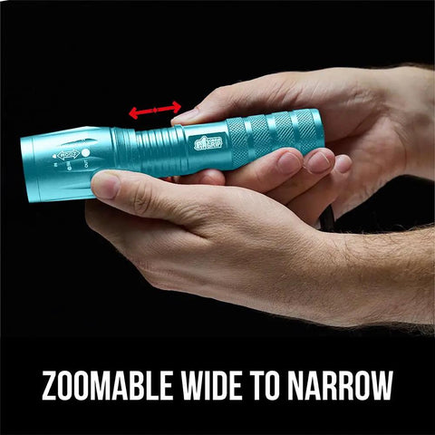 Person holding Ultra Bright LED Tactical Flashlight With Zoom, Five Modes, Water Resistant, Compact Mini Light, Turquoise