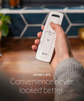 Person holding Pure White RTS Remote for One Motorized Shade or Group, Single Channel Control, easy setup for home use.