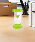 2 Minute Mini Hexagon Sand Timer In Grass Green on office desk, quick visual reminder for toothbrushing, studying, cooking, and meetings.