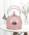 Stainless Steel Whistling Tea Kettle for Stovetop and Induction, 2.6 Quart Teakettle, pink finish on a white table with flowers.