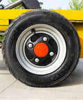 Heavy Duty Hydraulic Lift Table And Four Wheel Manual Push Platform built tough rubber tire close-up for easy transport.