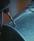 Close-up of a drill bit from the 7 Piece Pro Grade Precision Drill Bit Set For Rotary Tools Heavy Duty All In One, drilling into soft metal.