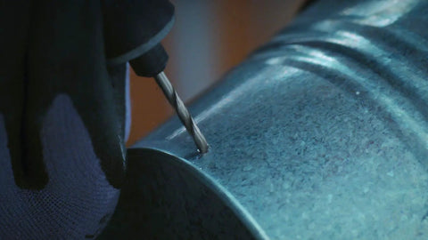 Close-up of a drill bit from the 7 Piece Pro Grade Precision Drill Bit Set For Rotary Tools Heavy Duty All In One, drilling into soft metal.