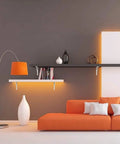 Room with modern decor featuring orange couch, 12 Inch Heavy Duty L Shelf Brackets Set Of 6 for DIY Floating Shelves on wall.