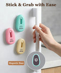 Hand grabbing fridge door next to colorful magnetic hooks with 'Stick & Grab with Ease' text.