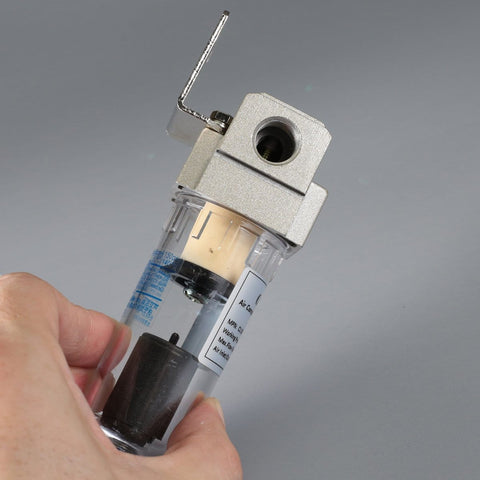 Hand holding Inline Pro Grade Air Filter And Moisture Trap With Automatic Drain For Shop And Garage, 26 CFM Separator