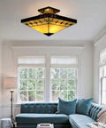 Tiffany Style Two Light Craftsman Semi Flush Ceiling Light with Antique Art Glass Shade in Beige in a cozy living room setting.