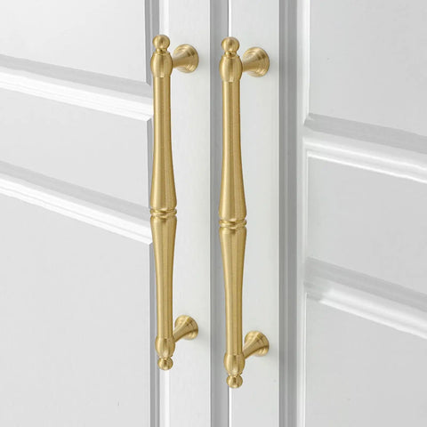 Killer Solid Brass Cabinet Pull 266mm Double Hole Style With Bombproof Gold Plating For Wardrobes And Drawers Top Shelf Hardware Knockout Design Durable Smooth Action Rig close-up of two gold cabinet pulls on a white cabinet.