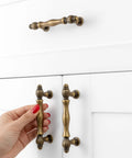 Set Of 10 Antique Brass Cabinet Pulls 3 Inch Center To Center Drawer Handles For Kitchen Cabinets installed on white cabinet