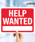 Person holding Help Wanted sign with bright red background in indoor setting, focuses on Now Hiring Signs 12x9 Waterproof Plastic For Businesses Bright Red And Bold Outdoor Indoor Use Pack Of Four Weatherproof Signs Designed To Attract Fast Applicants And Boost Hiring