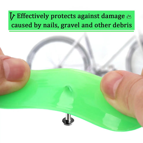 Close-up of Two Pack Green Bike Tire Liners being bent by hands, demonstrating puncture resistance with a bike wheel in the background.