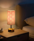 Dope Dog Paw Print Watercolor Bedside Lamp With 3 Way Dimmable Touch Control And Built In Charging Station illuminated on nightstand