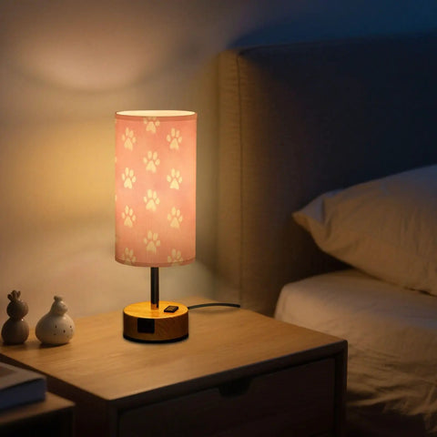 Dope Dog Paw Print Watercolor Bedside Lamp With 3 Way Dimmable Touch Control And Built In Charging Station illuminated on nightstand