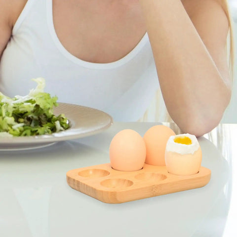 Organic Bamboo Deviled Egg Platter featuring six secure grid wells, eggs displayed on kitchen counter beside a salad.