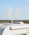 Three Blade Vertical Axis Wind Turbine Kit With 12V 40W 3-Phase Permanent Magnet Motor installed on camper roof, outdoor use.