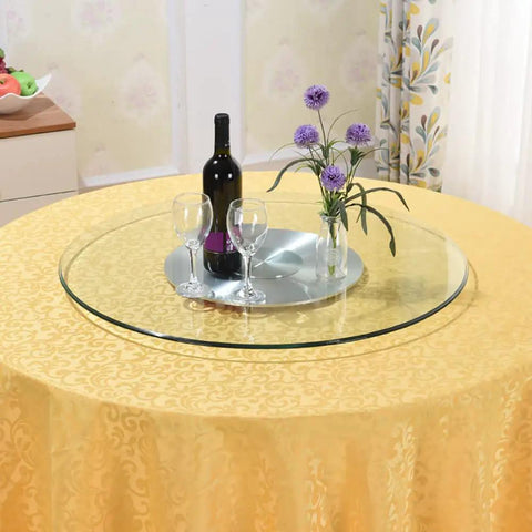 Premium Tempered Glass Lazy Susan Turntable featuring a sleek swivel design on a dining table with wine and flowers.