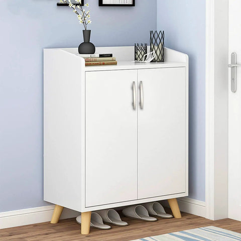 White cabinet with wooden legs in a room corner, displaying decor; shoes stored underneath. Handles similar to 25 Pack Solid Zinc Alloy Cabinet Handles Brushed Nickel Arch Drawer Pulls 3 Inch Center to Center Built Tough Kitchen Bath Cupboard Hardware for Cabinets and Drawers.