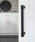 Close-up of matte black cabinet handle installed on white cabinet, part of 10 Pack 5 Inch Matte Black Cabinet Handles For Kitchen Cabinets And Drawers Alloy Drawer Pulls Solid Cabinet Hardware Wide Application Easy To Install Durable And Stylish Includes Mounting Screws For Quick Install And Smooth Operation.