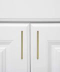Modern Square Cabinet Pull Handle With Golden Champagne Finish, 5.39-Inch Length, 5-Inch Hole Center, installed on white cabinet doors