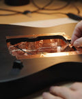 Applying High Conductivity Copper Foil Tape For Guitar EMI Shielding inside a guitar cavity to reduce interference in home audio projects.