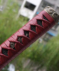 Close-up of a DIY Japanese samurai katana tsuka handle with alloy fittings, 10.2-inch, dyed wrap, wood core, intricate detail.
