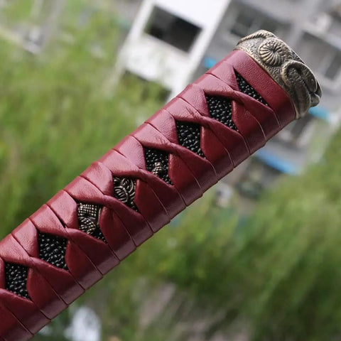 Close-up of a DIY Japanese samurai katana tsuka handle with alloy fittings, 10.2-inch, dyed wrap, wood core, intricate detail.