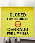 Restroom Closed For Cleaning Sign English And Spanish Hanging Doorway Safety Sign Yellow in a bathroom scene