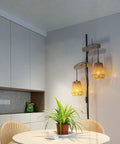 Two Light Rattan Floor Lamp With Independent Control Switch in cozy dining room setting with rustic lampshades, 68-inch tall.