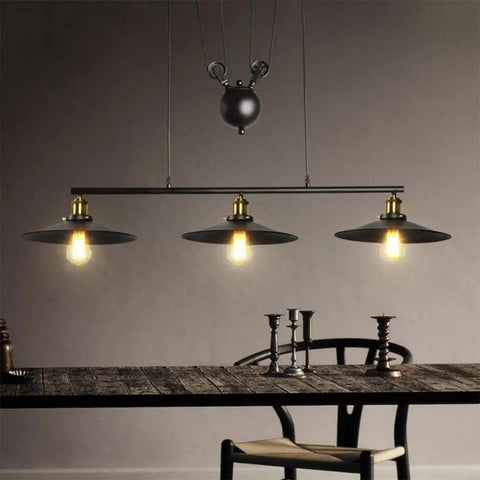 Top Tier Industrial Led Chandelier With Reliable Pulley Pendant Setup Modern hanging light fixture over a rustic wooden table.