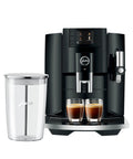 Next Level 5th Gen Automatic Smart Coffee Machine Bundle Featuring Piano Black Finish Plus Matching Glass Milk Frothing Container with brewed espresso.
