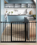 Auto Close Walk Through Baby Gate For Stairs And Doorways With Pressure Mount Or Hardware Mount Kid Safe Pet Friendly Tension Metal Gate In Black Fits 62 To 65 Inches Sturdy Design For Quick Setup And Long Lasting Safety For Kids And Pets installed in a modern kitchen doorway