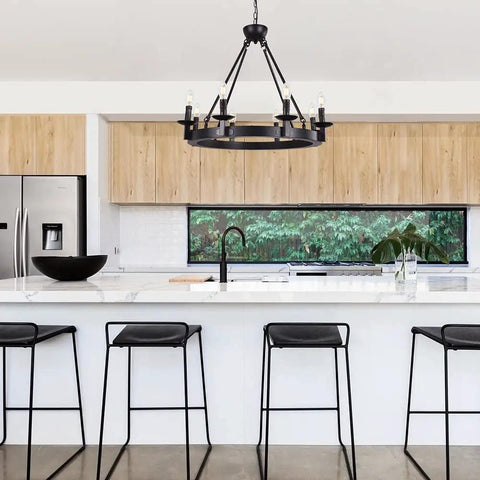 Black Farmhouse Wagon Wheel Chandelier With Eight Exposed Lights Dope Industrial Iron Ceiling Fixture over kitchen island.