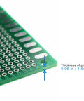 Close-up of Three Pack 15X20CM Double Sided Protoboard For DIY Soldering And Prototyping With Pre Tinned 1 mm Holes PCB Boards showing thickness.