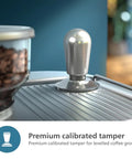Top Shelf Semi Automatic Espresso Machine With Integrated Grinder And Dual Wall Baskets For Fresh Single Double Shots Plus Americano Brewing In Sleek Metal Silver With Calibrated Tamping Tool on kitchen counter with coffee beans.