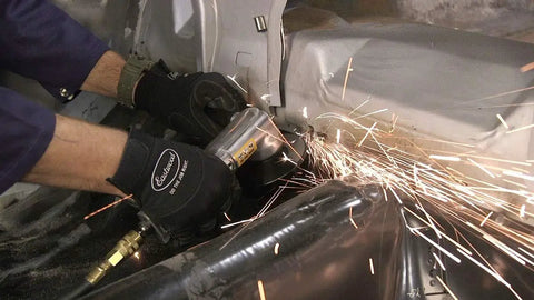 Pro Grade 4 Inch Pneumatic Air Angle Grinder With High Torque Ball Bearing Motor working on metal, producing sparks during auto body cutting.