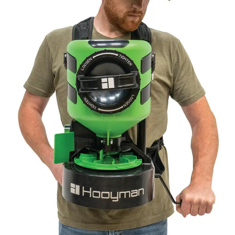Manual Seed Spreader With 35 Pound Hopper For Food Plots And Land Management Detachable Harness in use by person