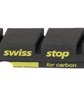 Close-up of FlashPro Black Prince Rim Brake Pad for carbon rims, showing SwissStop branding, part of a 4 pack for carbon and aluminum rims.