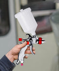 Person holding All In One HVLP Automotive Spray Gun Kit With 3 Nozzles 1.4 mm 1.7 mm 2.0 mm 600cc Cup And Cup System Connector DIY Friendly