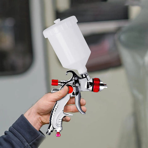 Person holding All In One HVLP Automotive Spray Gun Kit With 3 Nozzles 1.4 mm 1.7 mm 2.0 mm 600cc Cup And Cup System Connector DIY Friendly