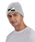 Dope Black And White Grid Pattern Knit Beanie Hat For Winter Super Cozy Acrylic Skully Cap That Keeps You Toasty In Frosty Days Lightweight Yet Insulated Everyday Wear For Street Style Fits worn by a male model.