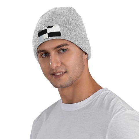 Dope Black And White Grid Pattern Knit Beanie Hat For Winter Super Cozy Acrylic Skully Cap That Keeps You Toasty In Frosty Days Lightweight Yet Insulated Everyday Wear For Street Style Fits worn by a male model.