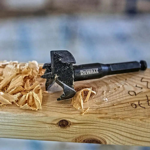 Self Feed Drill Bit 2 Inch With 7/16 Quick Change Shank, Three Hardened Cutting Surfaces For Long Life on wooden board