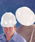 Two white hard hats, front and back view, worn by individuals. V-Gard Full-Brim Hard Hat With Fas-Trac III Ratchet Suspension visible.