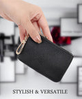 Hand holding a Full Grain Leather Coin Purse And Keychain Wallet With Slick Pull Zipper Closure Handy Card Slots Stylish Matte Black Finish.