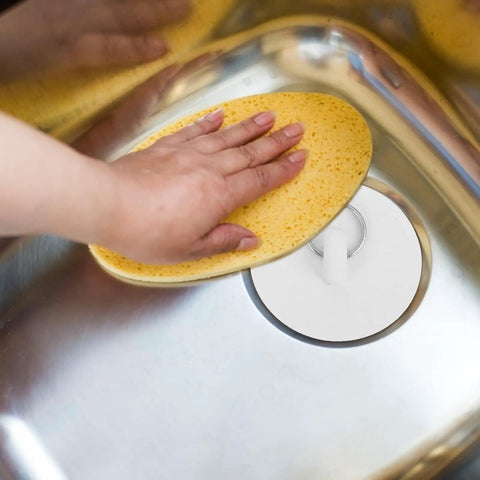 Rubber Bath Tub Drain Stoppers 4pcs with Pull Ring for Basins being tested in a sink with a hand pressing a yellow sponge.