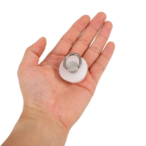 White Round Drain Stopper for Bathtubs and Kitchen Sinks held in hand, showcasing its compact size and silicone material.