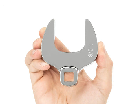 Person holding one half inch drive to one and three eighths inch crowfoot wrench ultra compact access tool, steel engraved size marking